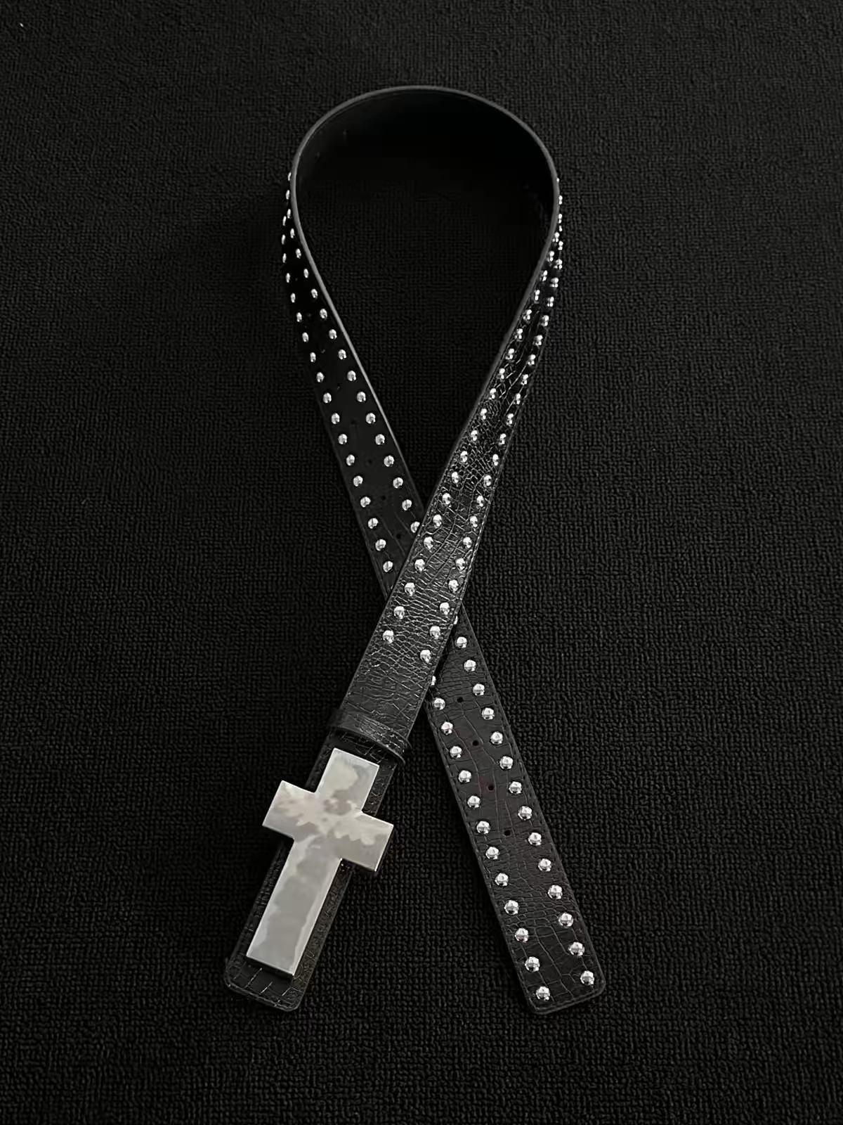 Black crackle belt with double-row dome studs and a large silver cross plaque