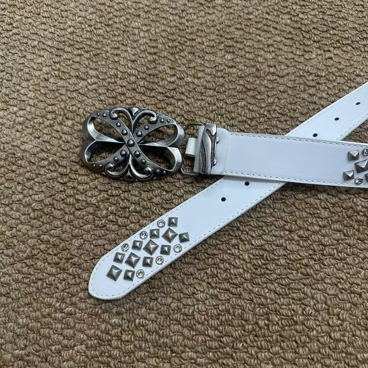 White pyramid-stud punk belt with rhinestones and antique floral buckle