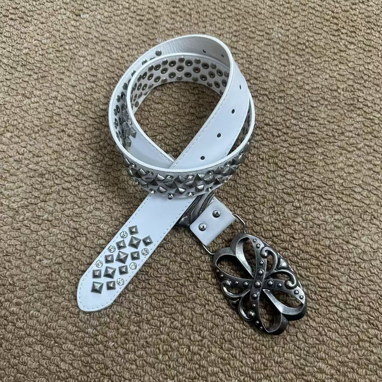 White pyramid-stud punk belt with rhinestones and antique floral buckle