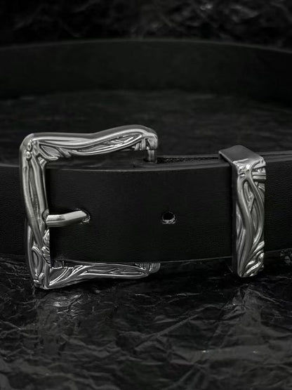Black belt with carved western buckle and silver broken-sword tip