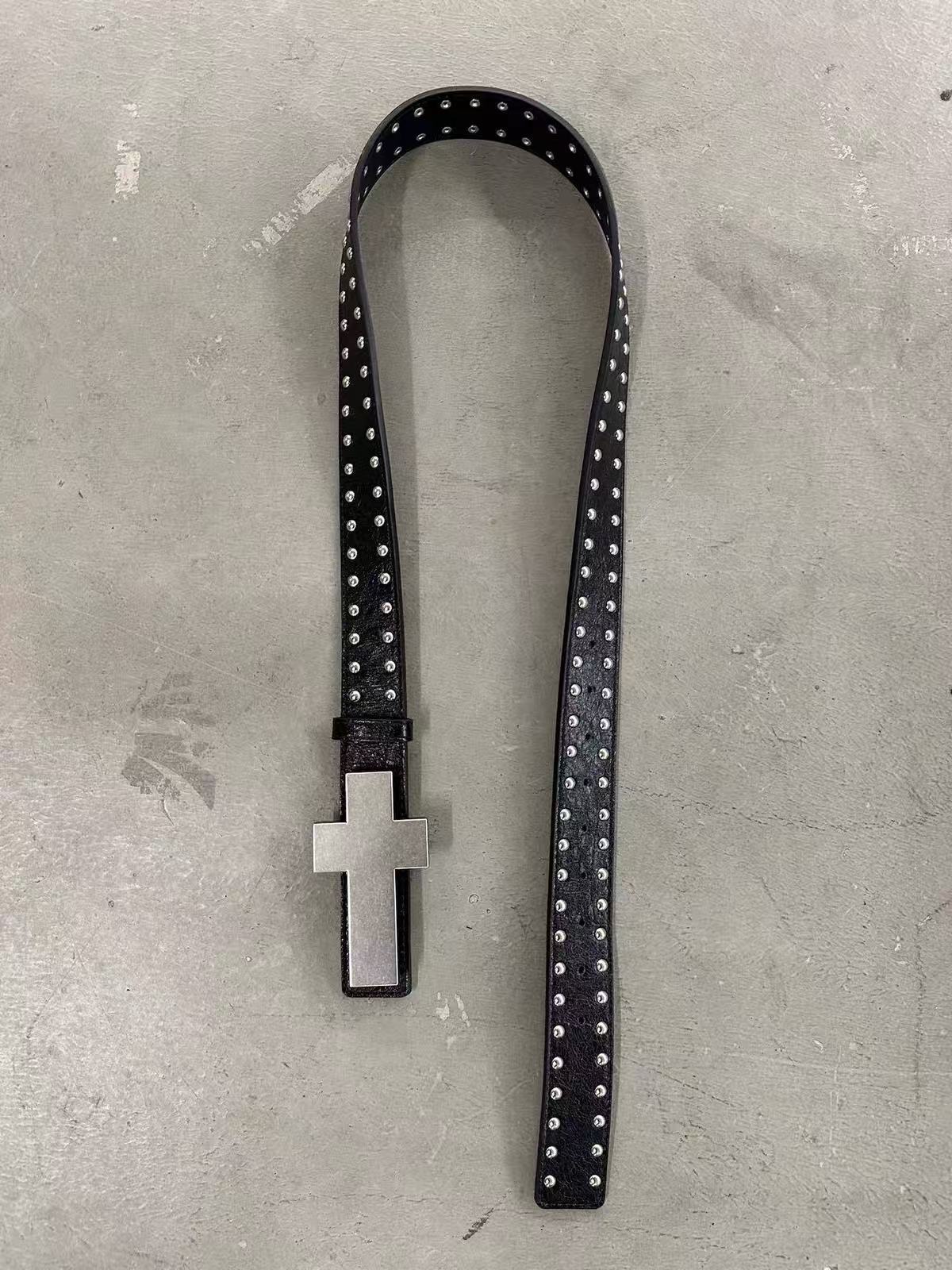 Black crackle belt with double-row dome studs and a large silver cross plaque